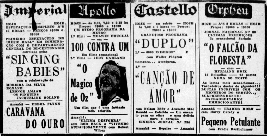 Fotografia em preto e branco retangular horizontal de um excerto do jornal gaúcho Diário de Notícias, de 1940. O recorte é dividido em quatro colunas iguais, que apresentam a programação de filmes dos cinemas Imperial, Apollo, Castello e Orpheu. [Fim da descrição]